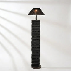 Black textured floor lamp with a cone-shaped shade on a white background