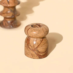 brown marble Astra Tea Light Candle Holder on a beige background