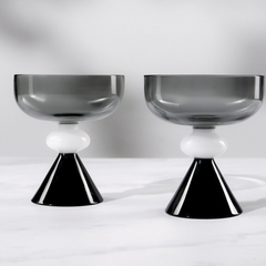 Close view of Two Twilight glass dessert bowls supported by black cone design base