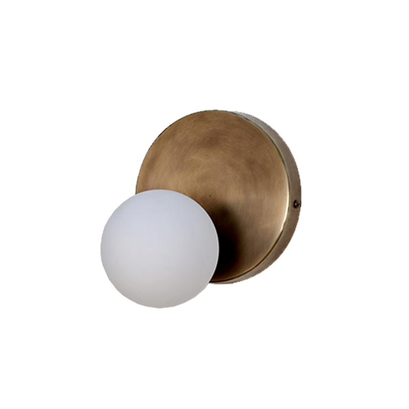 A wall sconce with a brass finish and a frosted glass globe, viewed from above.