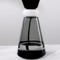 Modern glass vase with black and white design on top