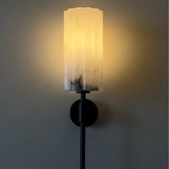 Wall-mounted lamp with a textured alabaster stone shade.