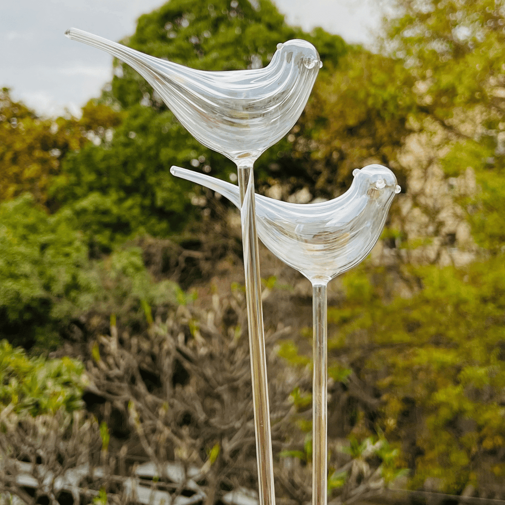 Handcrafted clear glass birds, varying heights, nature-inspired decor