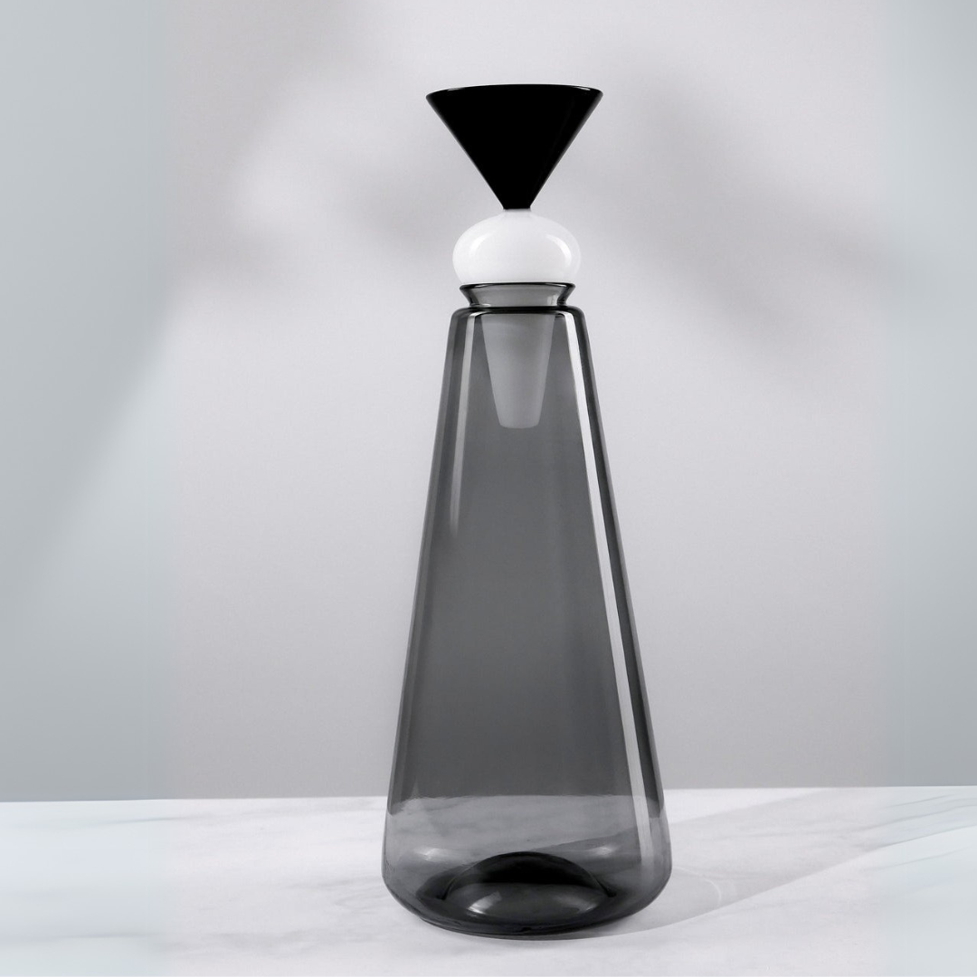 Tall, Twilight Glass Decanter with a black and white top on a light gray background