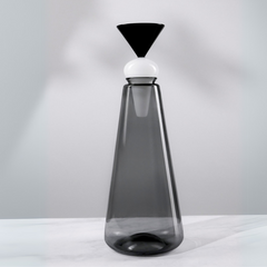 Tall, Twilight Glass Decanter with a black and white top on a light gray background