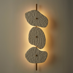 Modern style Organic Wall Lamp with a white ceramic body and gold-colored metal accents. The warm dimmable glow adds sophistication to any space.