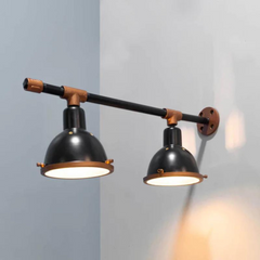 Dual Shade Wall Lamp in black and copper colors with dual lampshades mounted on a wall
