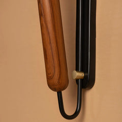 Dash & Dot Wall Sconce close view of Wooden and black metal holder on a beige background