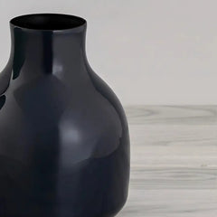 Close view royal blue yodo vase made of iron on a light wooden surface