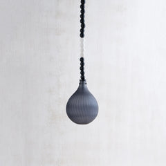 Black pendant light with beaded chain on a white background