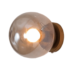 Aurora Noir wall sconce lit at dusk, warm ambient glow against a dark wall
