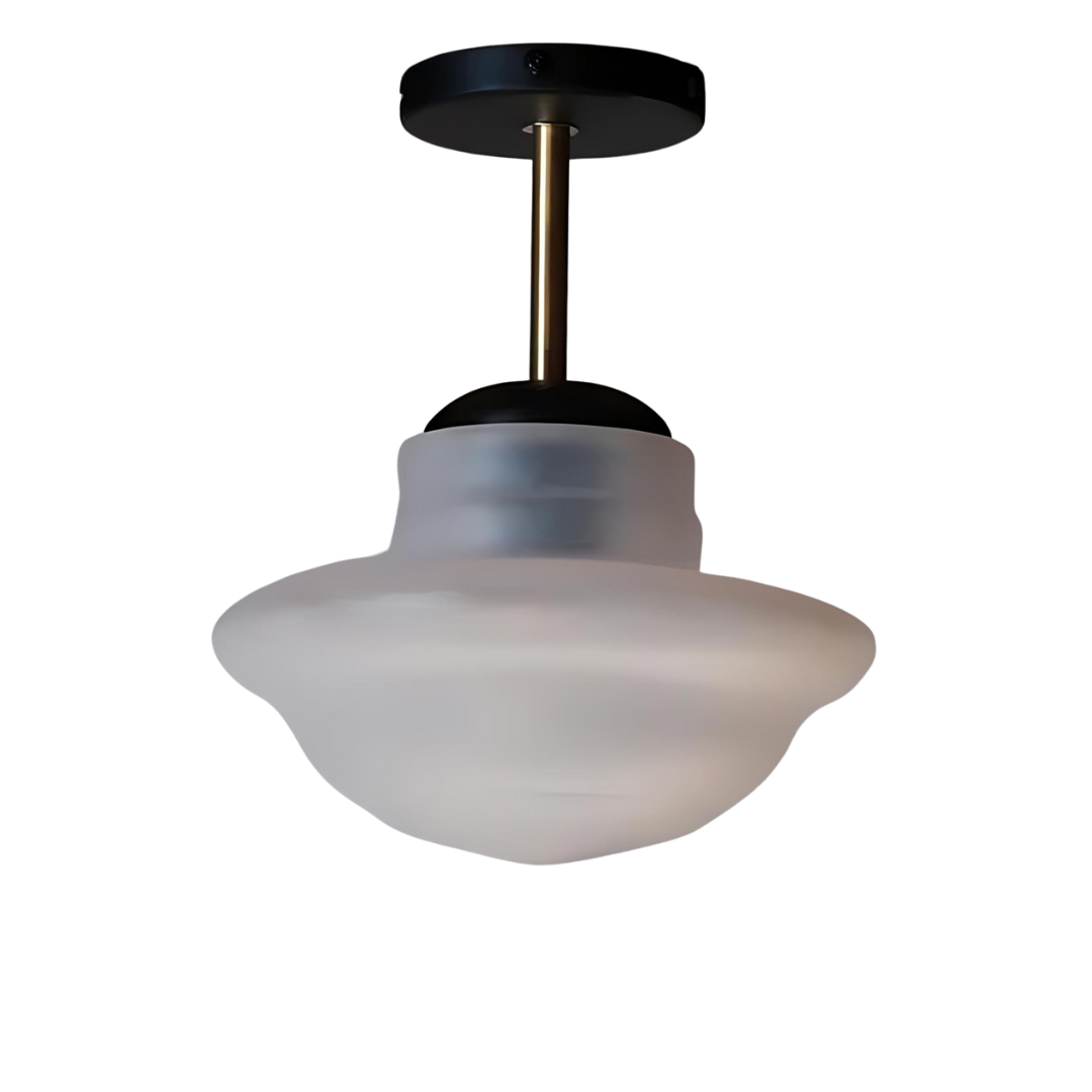 A ceiling-mounted lamp with a frosted white glass shade and a black and brass body, with visible wiring and mounting hardware.