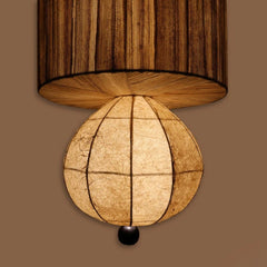 Wall-mounted lamp with wooden shade and textured spherical bulb on a brown background