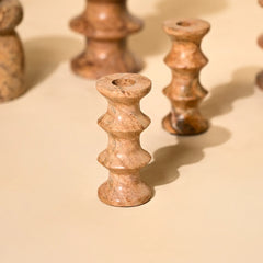Close-up of marble stone candle holders on a beige background