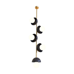 A vertical pendant light fixture with multiple opal glass globes and a brass metal frame, suspended by a chain.