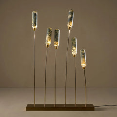 Modern outdoor floor lamp with cylindrical green marble-painted glass shades and warm golden outdoor frame. 