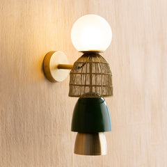 Totem Gold Wall Lamp – stacked mild-steel woven basket modules in gold finish with bold metal shade, mounted vertically on wall.