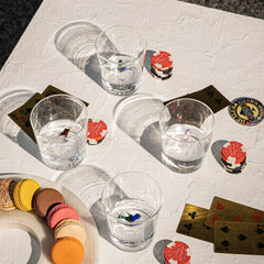 4 different design Wren Clear Drinking glasses on a textured surface