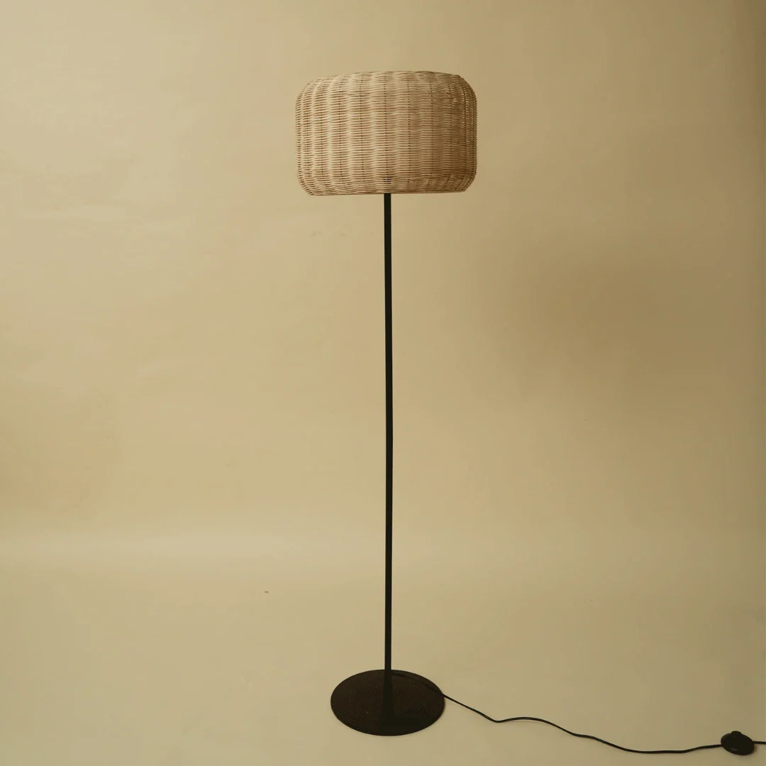 Bird's Nest rattan floor lamp with woven shade on a metal base
