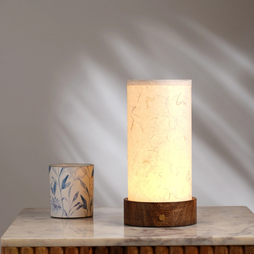 Portable Magnus table lamp with banana paper beige shade and a wooden base, warm glow light