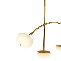 Close look of decorative ceiling chandelier in gold finish, curve and made of alabaster 