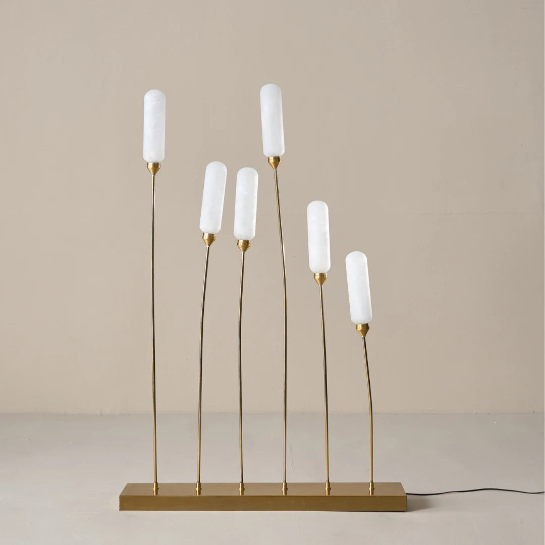 Modern floor lamp with white candle-like shades and gold bases for outdoors