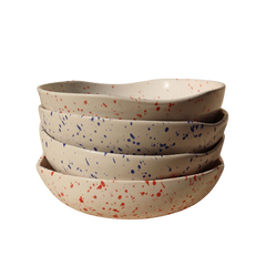 A round Speckled Ceramic bowl set of 4 with a speckled pattern, featuring a blend of white with red and blue speckles.