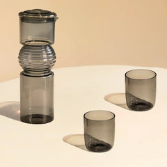 Set of Coil Glass Carafe and 2 Glasses on a beige background