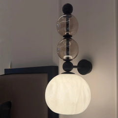 Modern wall lamp with glass spheres angled view showing the steel frame
