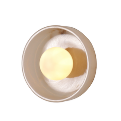 Closer look of a wall sconce with a round shade made of mottled white stone