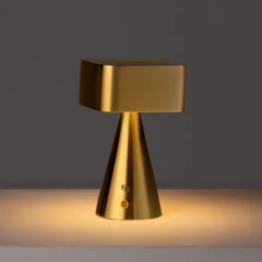 Portable Gold table lamp on a dark background
