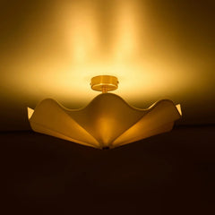 Camellia Ceiling Light lit with warm glow above brass canopy, side view