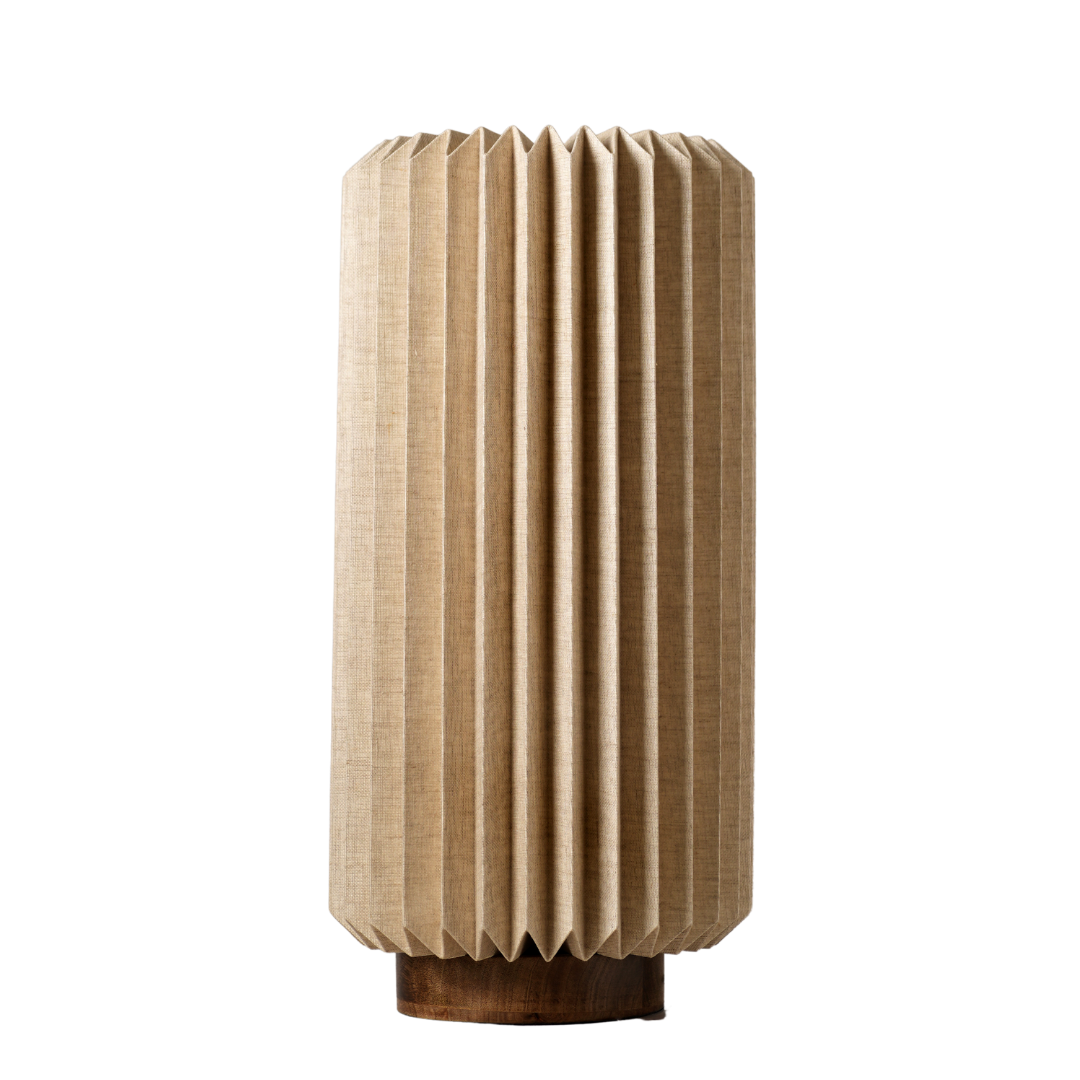 A cylindrical Serenity Table Lamp with a textured linen shade and a mango wood base.
