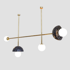 Designer chandelier with gold fixtures and black speckled glass shades