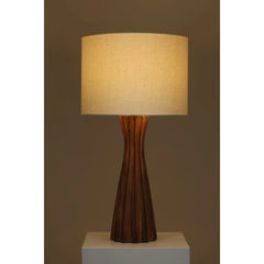 Tern Table Lamp with a textured wooden base and white fabric shade, warm lighting on a plain background