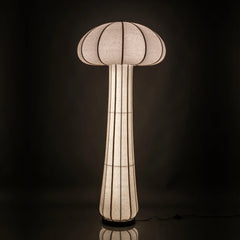 Mushroom-shaped floor lamp with a textured shade glowing in the dark