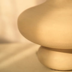 Close-up of a textured beige Verona Vase base on a neutral background
