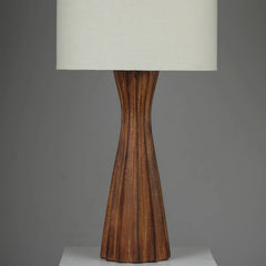 Close view of Tern Table Lamp with textured wooden base & white shade on a gray background