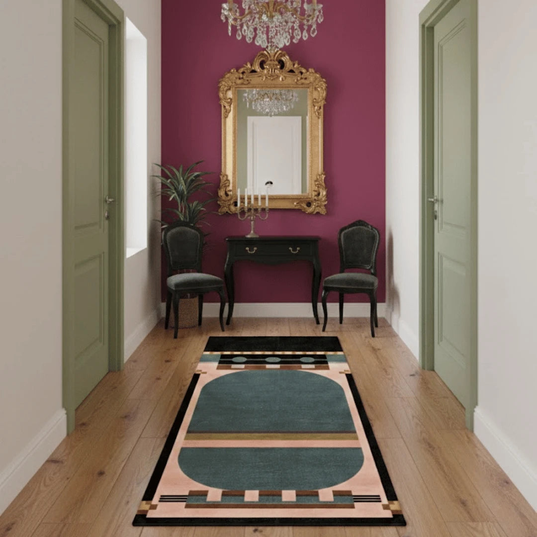 Decorative rug with geometric pattern on wooden floor in a room with purple wall and gold mirror.