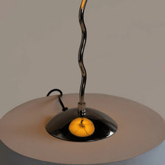Close-up of a black Wavy Table Lamp fixture made of glossy metal