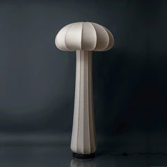 Mushroom-shaped floor lamp with a textured surface on a dark background