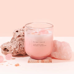 Crystal Energy Pure Love U-Glass Candle, blush glass with rose quartz crystals beside pink stone
