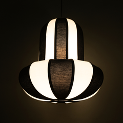 Unique pendant light with black and white striped design on a dark background