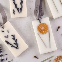 Lemongrass & Lavender - Wax Tablet - Set of 4, close-up of lavender and dried orange tablets on grey ribbons