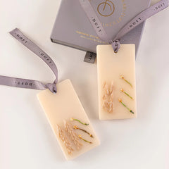Night Jasmine & Lavender Wax Tablet, two pressed botanical tablets beside grey gift box