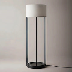 Floor lamp with a white shade and black metal base by black steel