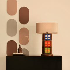 Unique Natura Table Lamp with a beige shade and design with tiles displaying natural prints of birds and leaves on a round base.