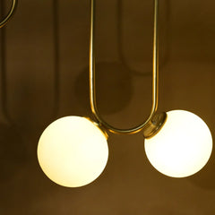 Close-up of a modern pendant light with two round glass shades 