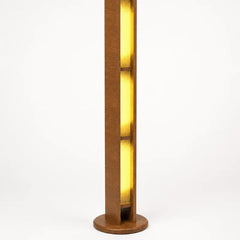 A modern vertical floor lamp with a warm brown wood frame and glowing yellow light panels, shown against a plain white background.