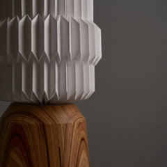Paper Totem Floor Lamp with white  ribbed folded-paper texture on a wooden stand